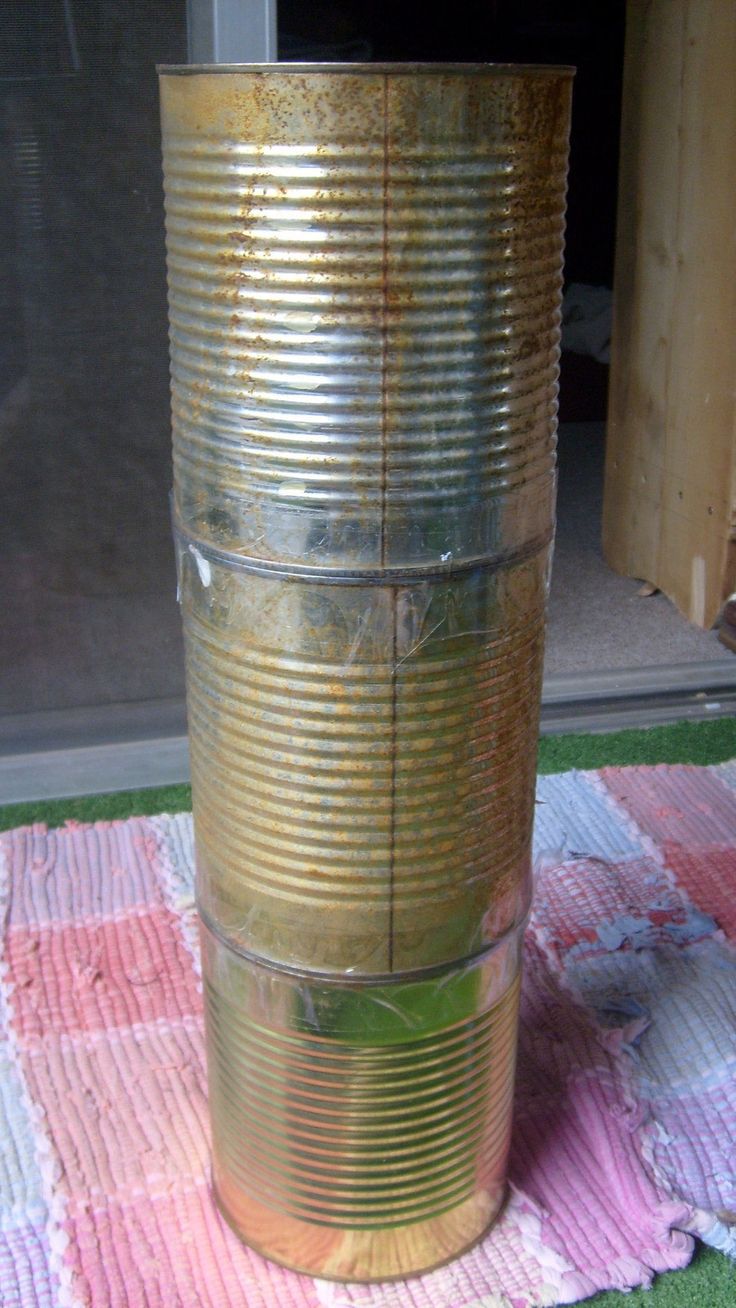 an old tin can sitting on top of a rug next to a glass door and window