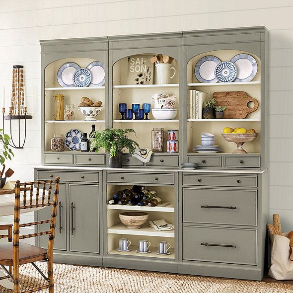 a dining room hutch with plates and bowls on it