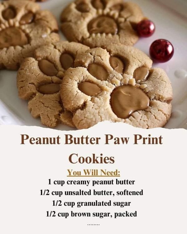 peanut butter paw print cookies on a white plate