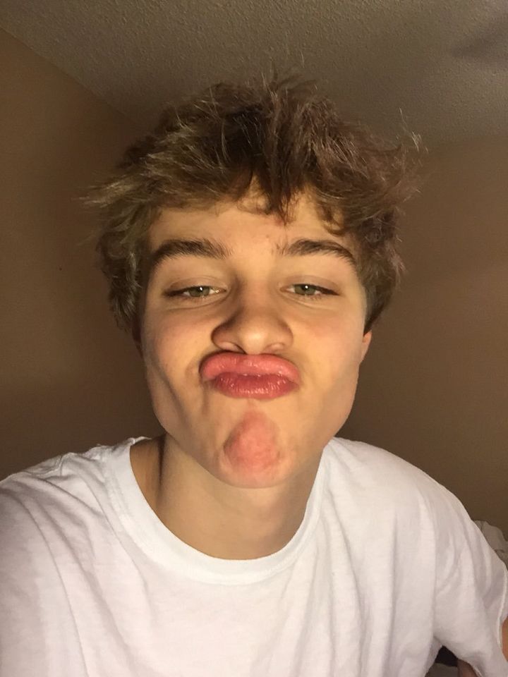 a boy making a funny face with his tongue out