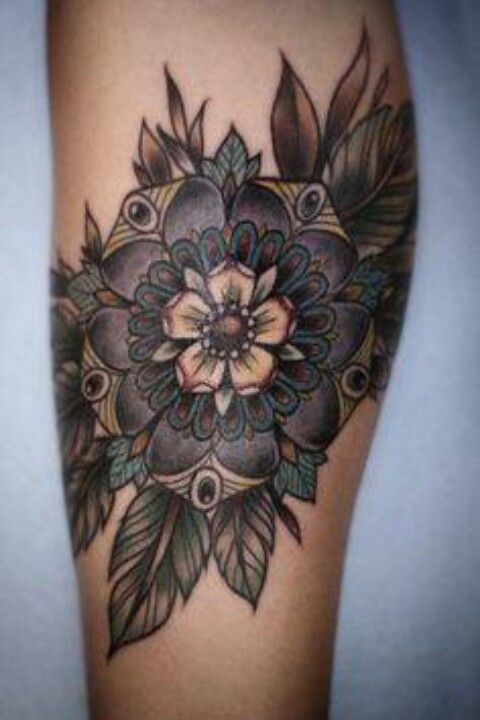 a woman's thigh with a flower tattoo on it