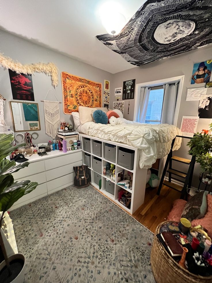 a bedroom with a bed, bookshelf and many pictures on the wall above it