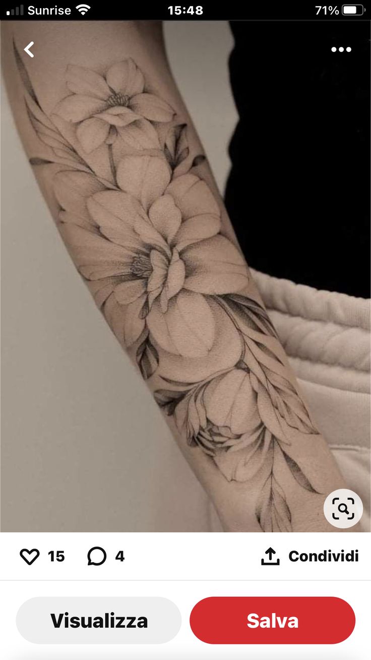 a woman's arm with flowers on it and an instagramr to the side