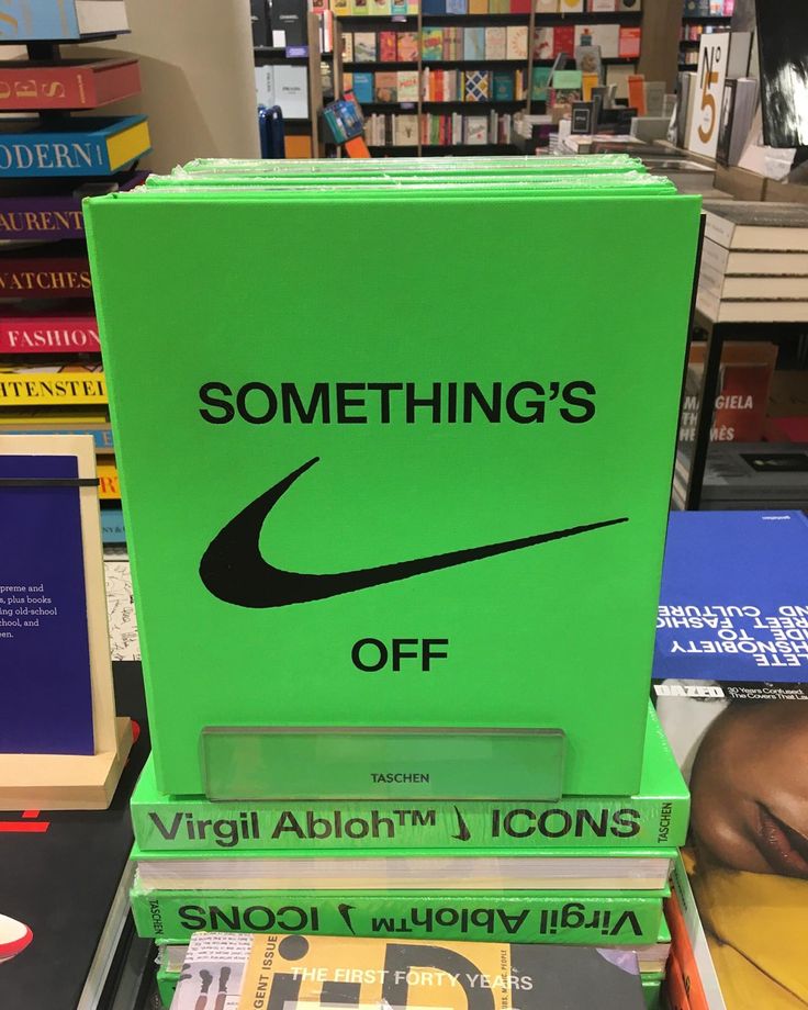 a stack of books sitting on top of each other in front of a book shelf