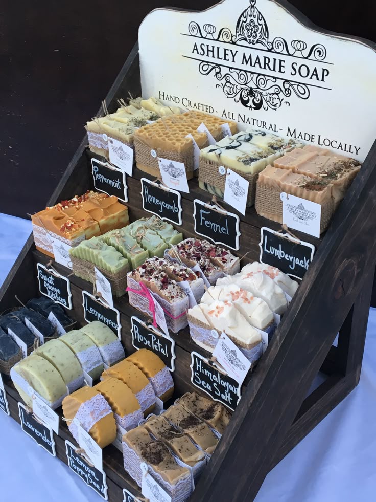 an assortment of soaps displayed on a wooden stand