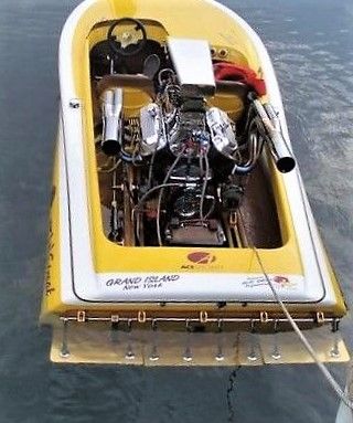 an inflatable boat is floating on the water with its engine attached to it