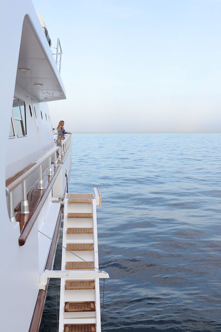 the stairs lead up to the upper deck of a large boat in the ocean,