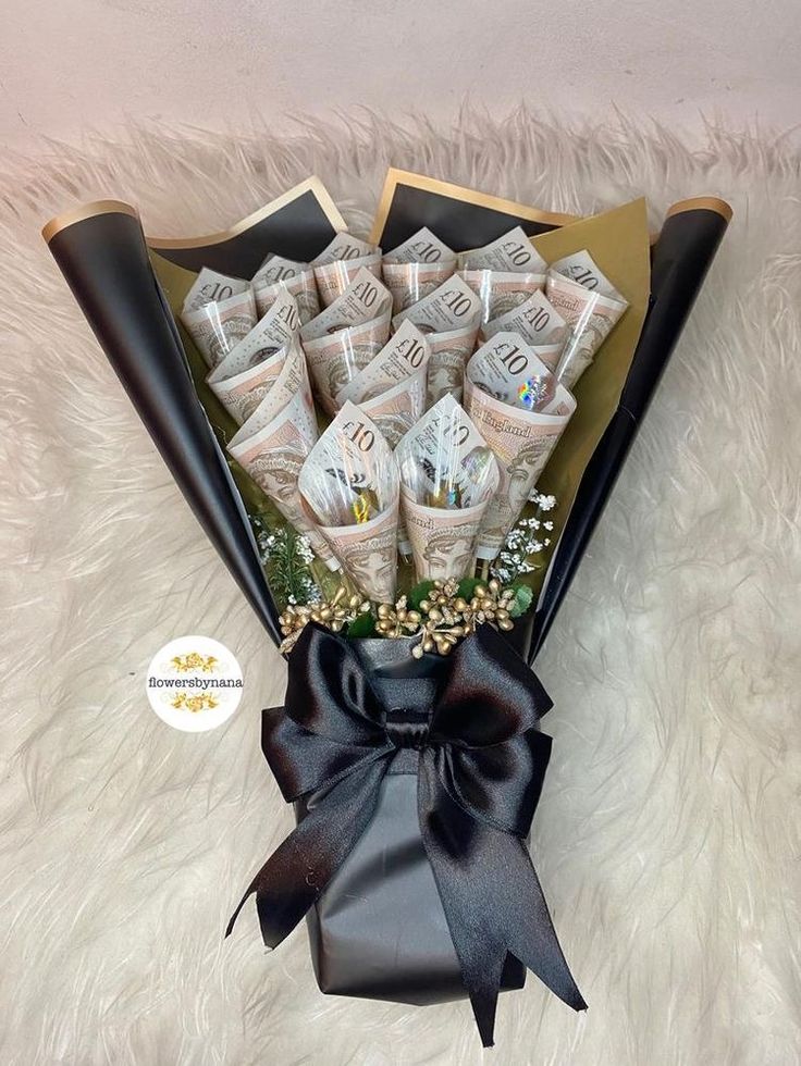 a bouquet of flowers is wrapped in black ribbon