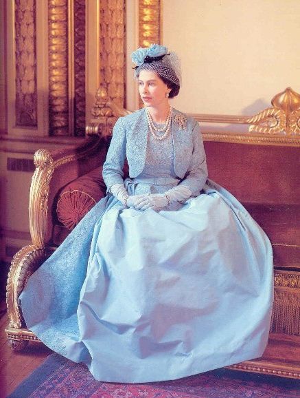 an old photo of a woman in a blue dress