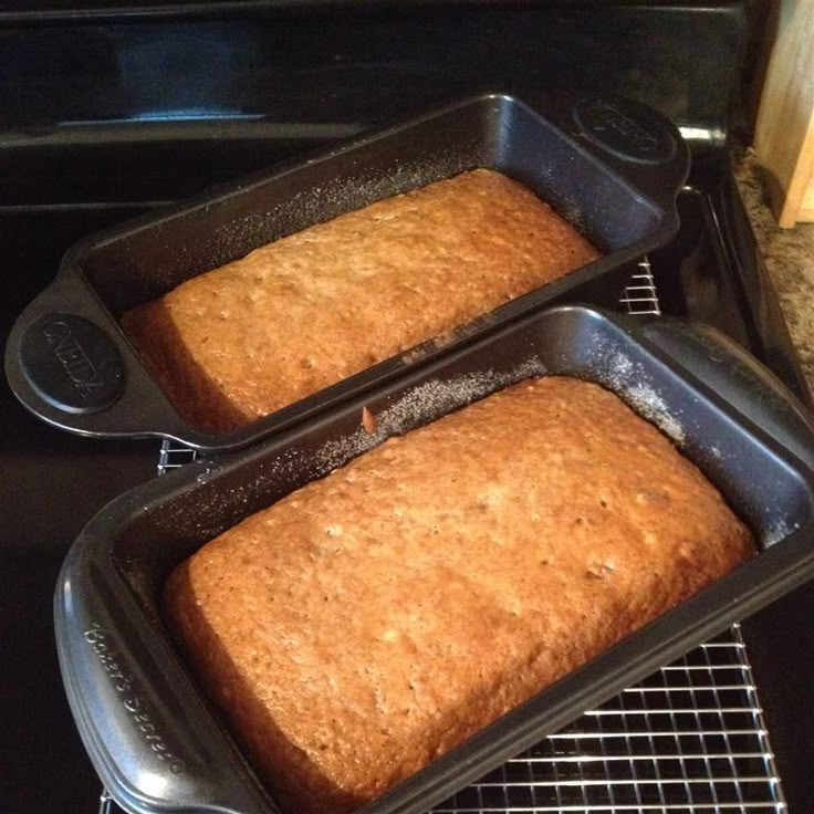 two loafs of bread sitting on top of an oven