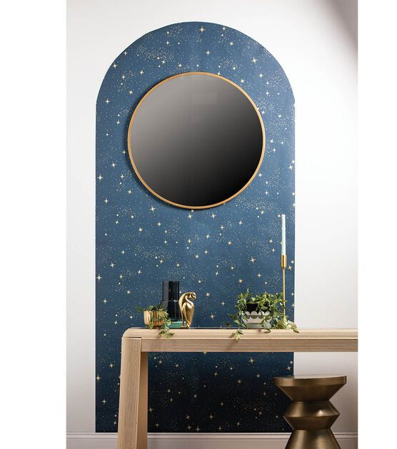 a table with a mirror on it in front of a wallpapered space background