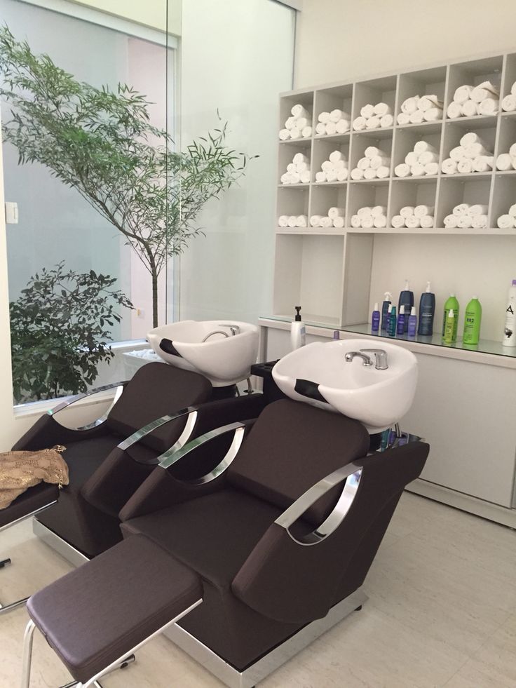 a modern salon with two sinks and chairs