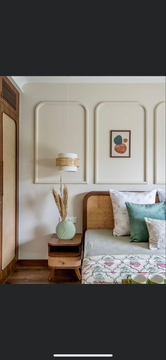 a bedroom with white walls and wood floors