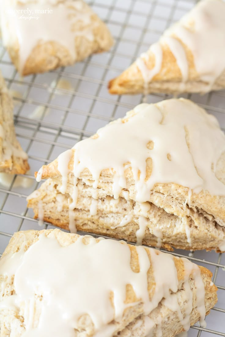 several pastries on a cooling rack with icing