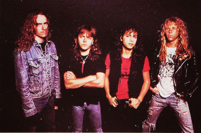 the group of young men are posing for a photo in front of a black background