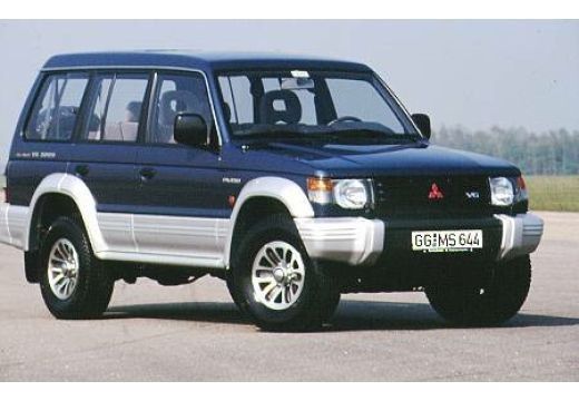 a black suv parked on top of a tarmac next to a grass covered field