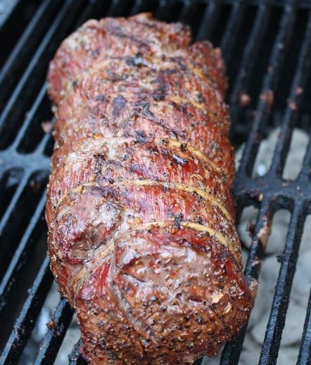 a piece of meat is cooking on the grill