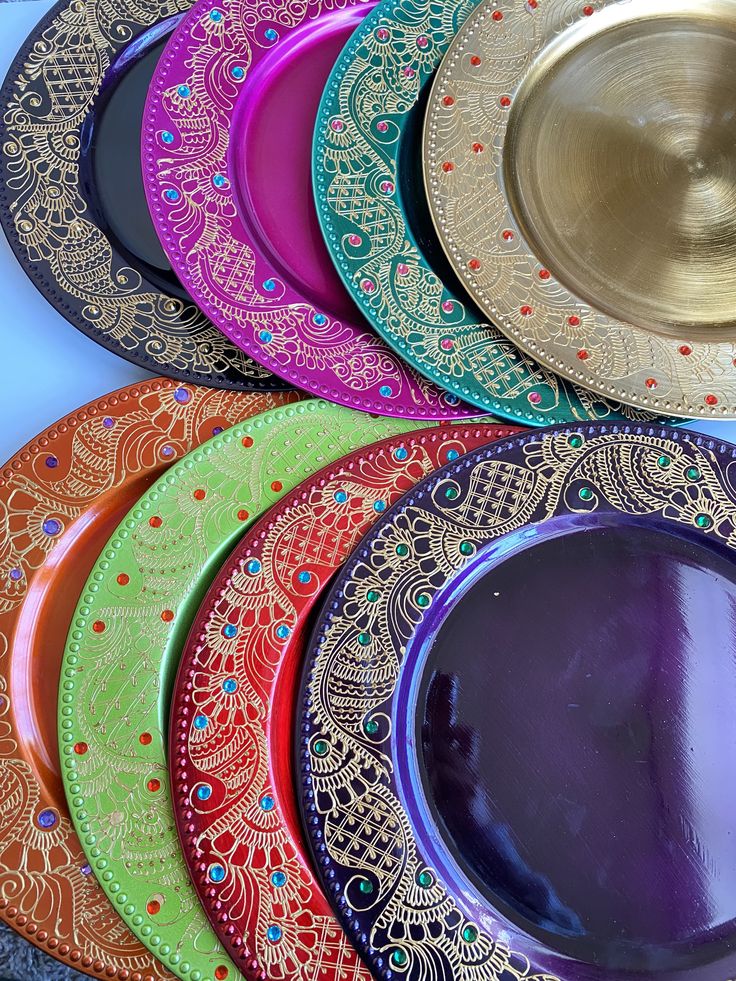 there are many colorful plates on the table