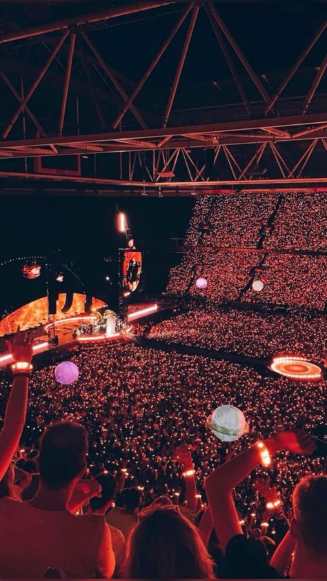 a large crowd at a concert in an arena