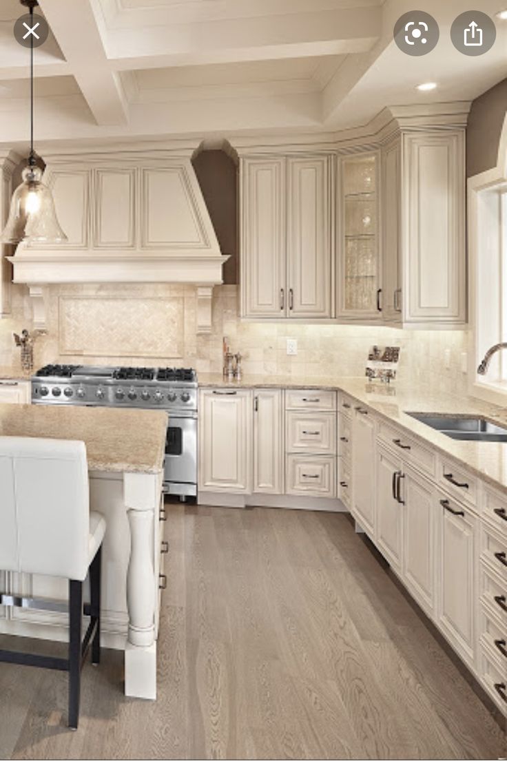 a large kitchen with white cabinets and an island