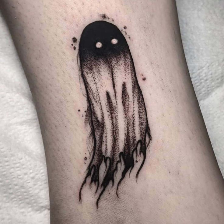 a black and white jellyfish tattoo on the ankle