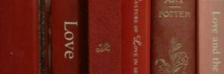 several red books are lined up on a book shelf with the words love written in white