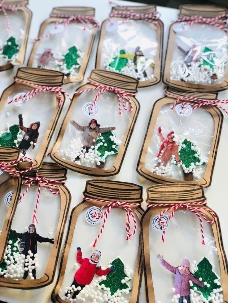 mason jars filled with christmas ornaments on top of a table