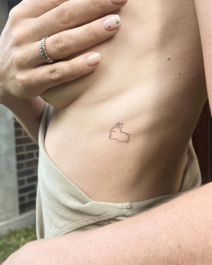 a woman with a small tattoo on her stomach