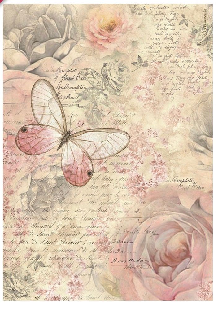 a pink and white butterfly with roses on it's back side, in front of a