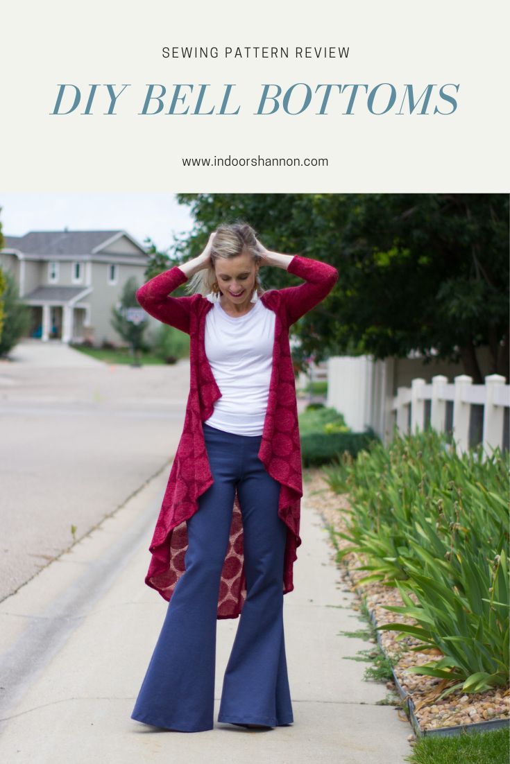 a woman is standing on the sidewalk wearing bell bottoms and a red cardigan sweater