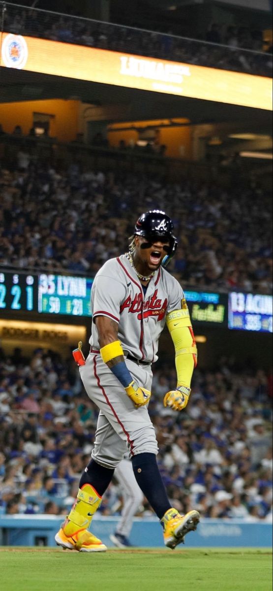 a baseball player is running on the field