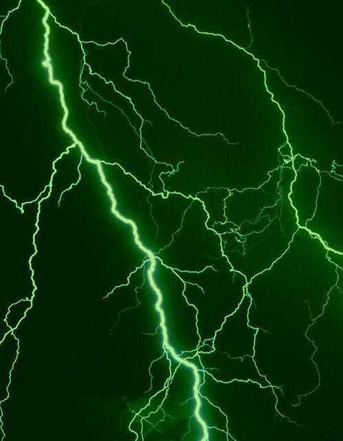 green and white lightning strikes in the night sky