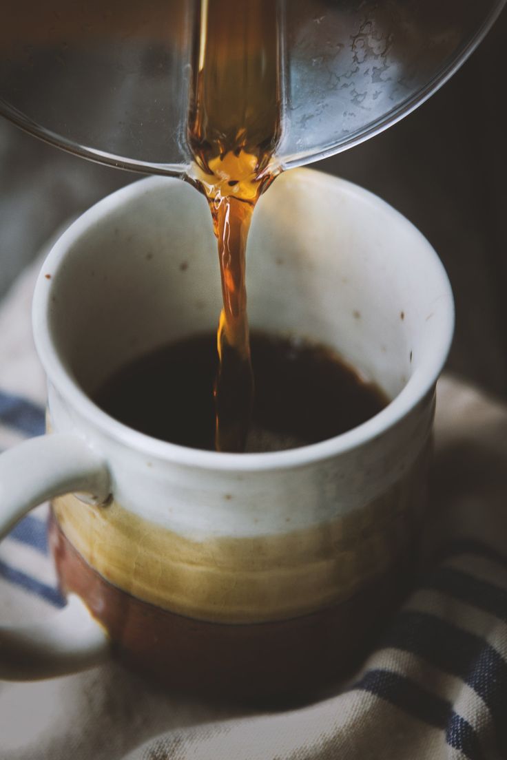 a cup filled with liquid being poured into it