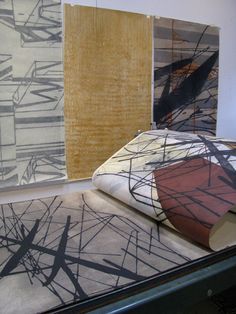 three different colored rugs on display in a room