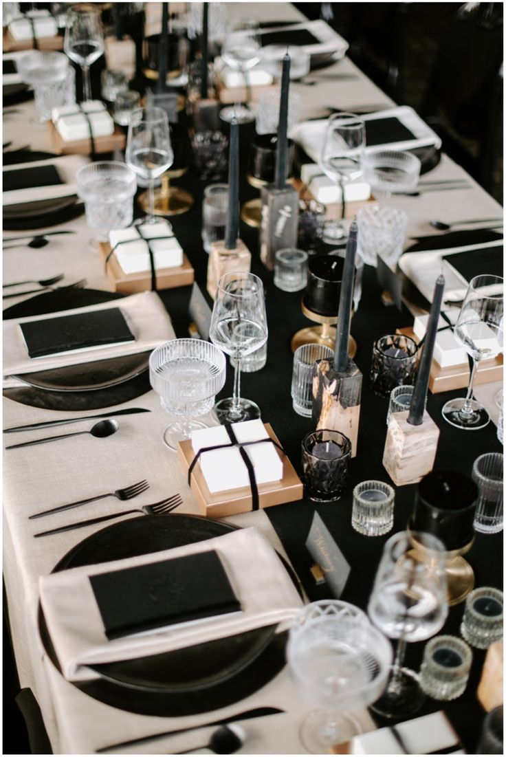 the table is set with black and white place settings