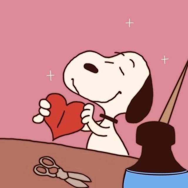 a cartoon dog holding a heart with scissors and pliers on the table next to it