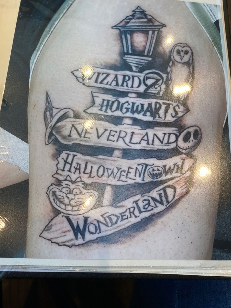 a harry potter tattoo on the back of a man's arm with lights around it