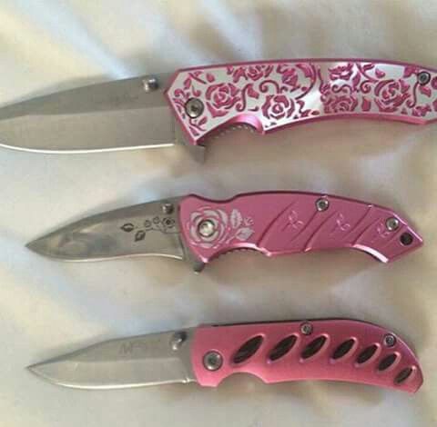 three pink knives with floral designs on them