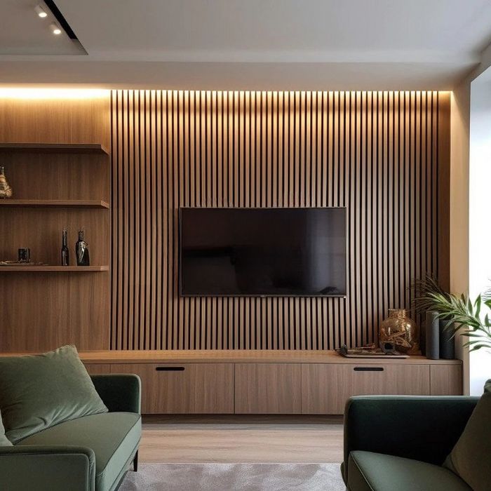 a living room filled with furniture and a flat screen tv mounted on a wall next to a wooden shelf