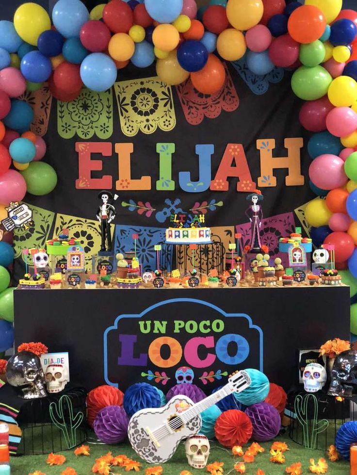 an elaborate display with balloons and decorations for a mexican themed birthday party