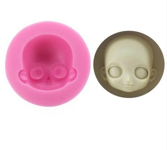 an image of a fake doll head in the shape of a pacifier