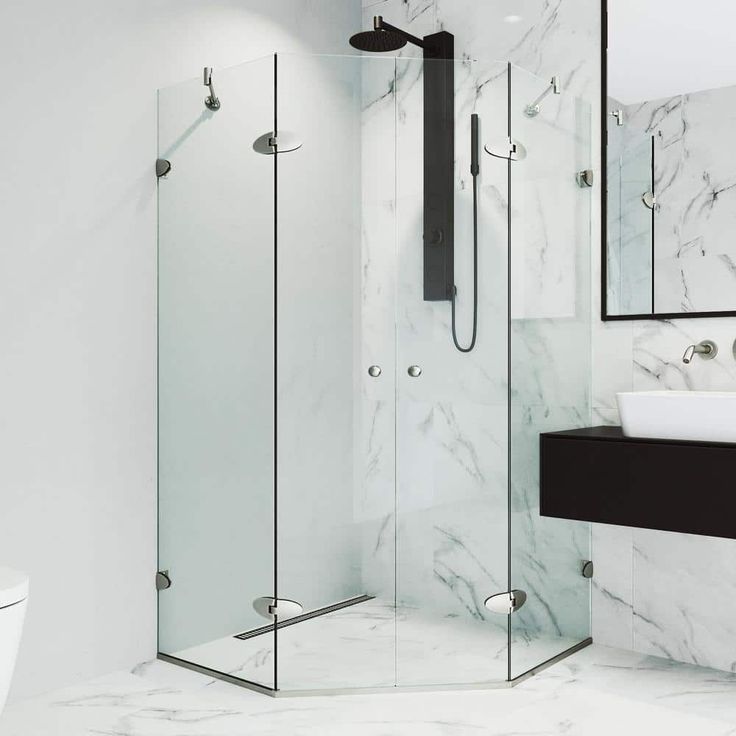 a white bathroom with marble walls and floor