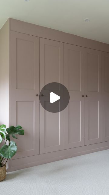 an empty room with several cupboards and a potted plant