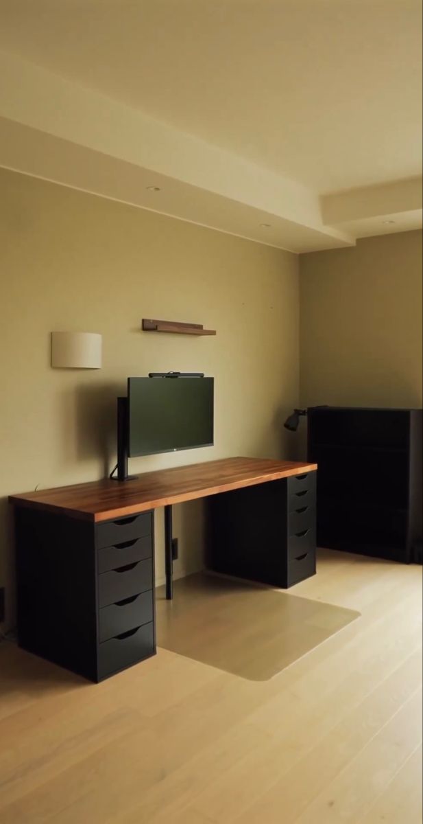 an empty room with a desk and television