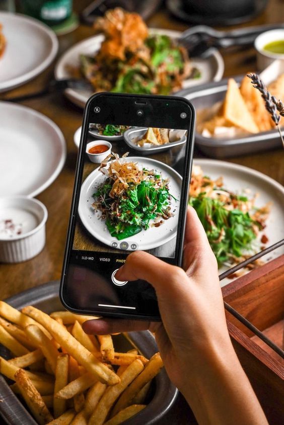 a person taking a photo of food on their phone