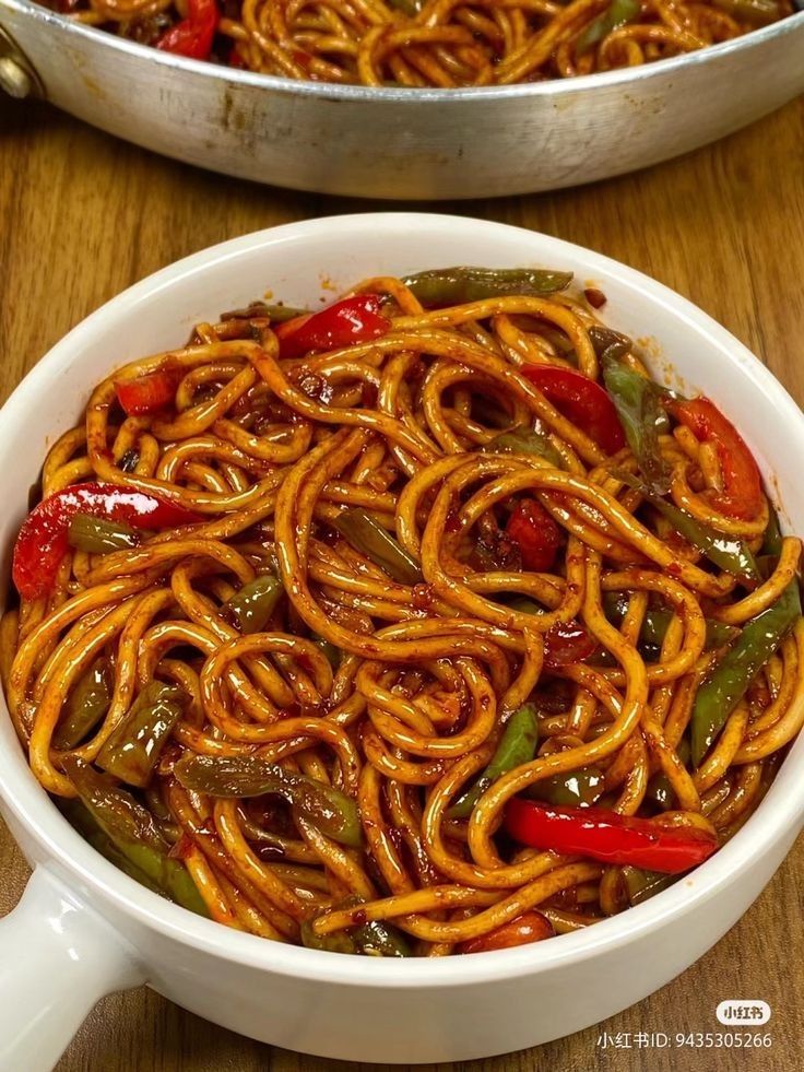 two pans filled with noodles and peppers