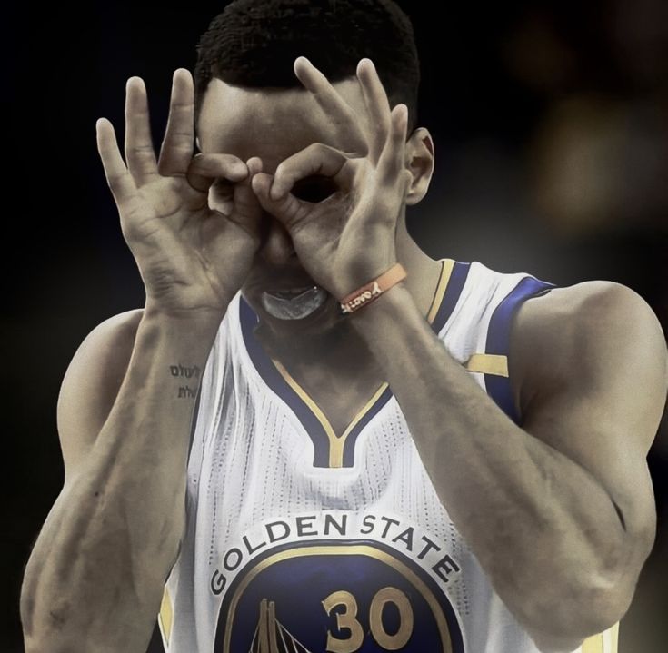 a basketball player covering his face with both hands