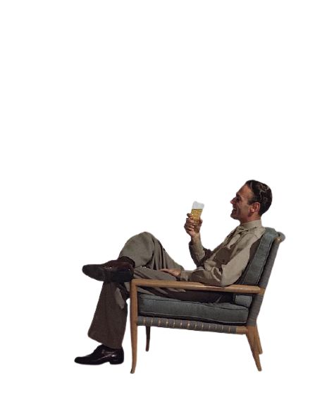 a man sitting in a chair holding a glass of beer and looking up at the sky