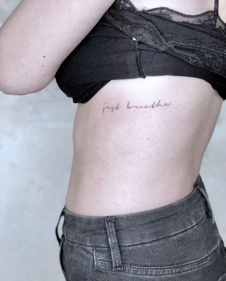 a woman with a small tattoo on her stomach