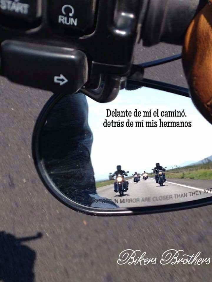 the reflection of two people riding motorcycles in a rear view mirror with a quote on it